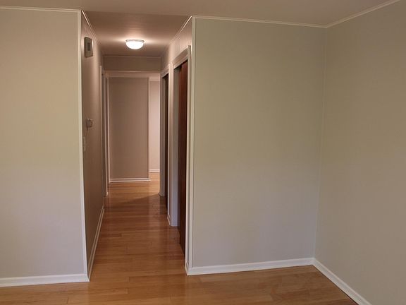 The main hall taken from living room. Closets on right, office then bedroom on the left. the laundry area then bathroom are to the right.