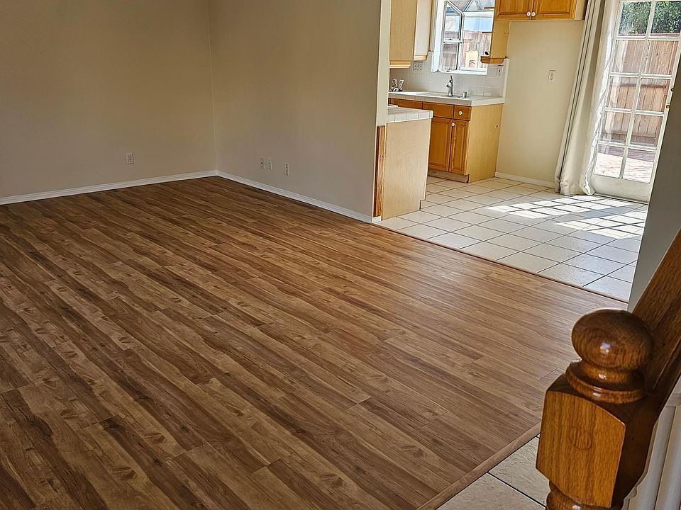 View from the front door to the living room, dining area, and kitchen.