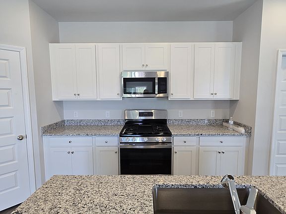 Granite countertops, gas stove, microwave, with lots of counter space