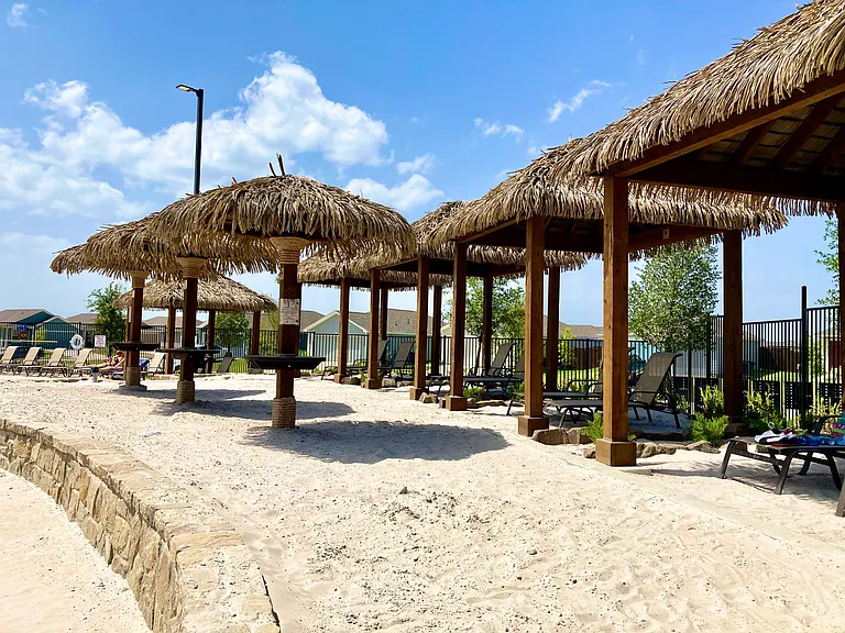 Tiki style cabanas with soft beach sand are available at the second pool.