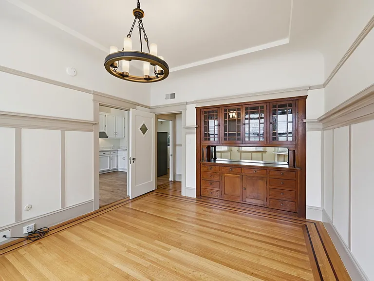 Spacious living room with historical character maintained.
