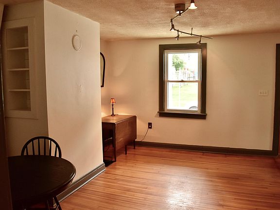 Living area adjacent to kitchen. Beautiful, original hardwoo