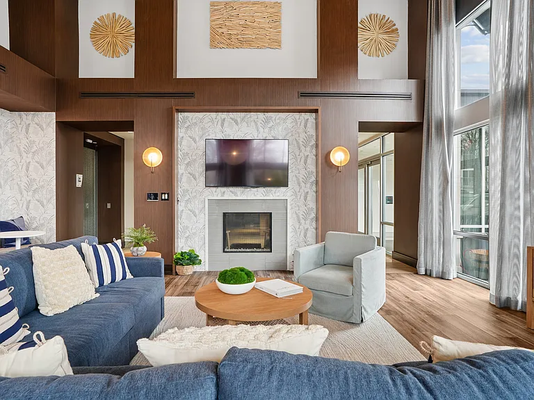 Resident lounge with seating, TVs and fireplace