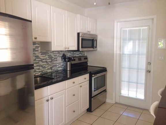 Modern kitchen with new tile and appliances 1 yr old