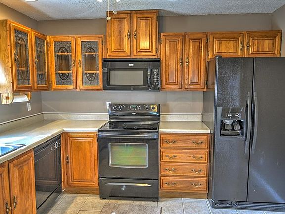 The kitchen has a full complement of appliances, and plenty of cupboard space.