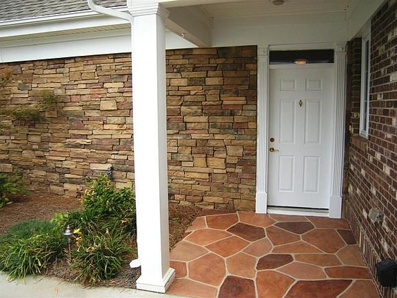 Covered entry with beautiful stamped concrete porch