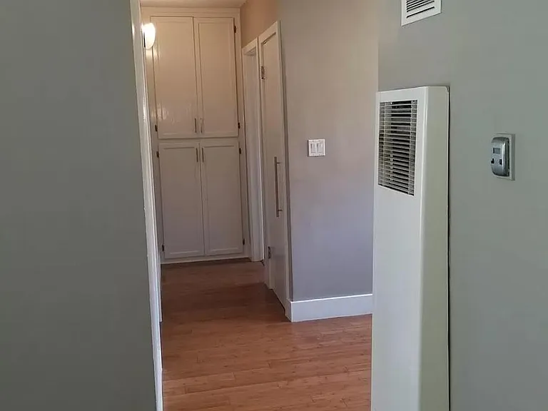 Hallway with cabinets and closet