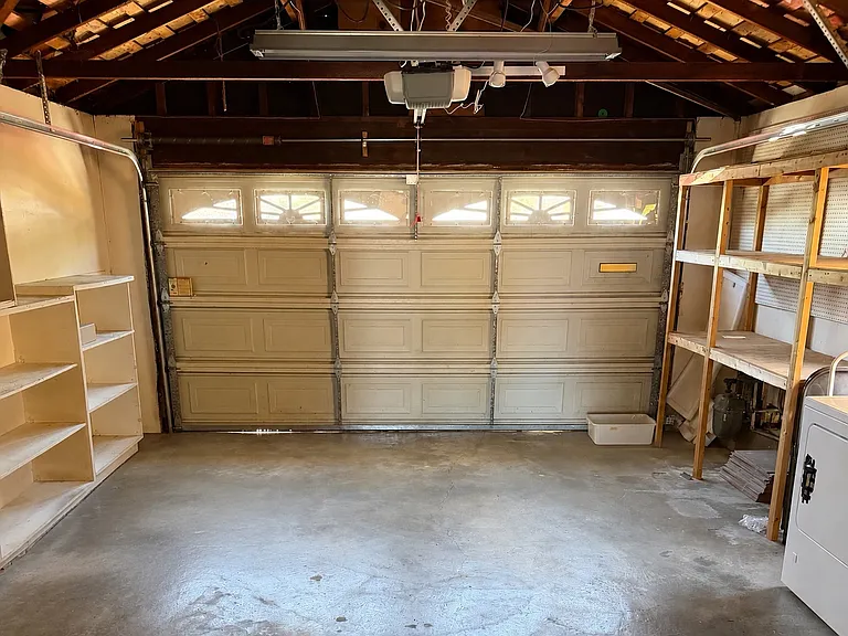 garage easily fits a car with lots of shelves for extra storage