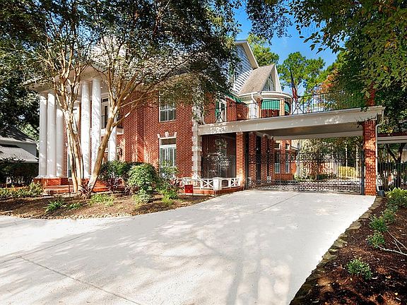 Gated porte-cochere leading to 3-car carriage house.