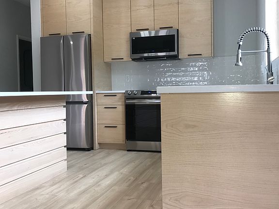 Large Modern Kitchen with an Eating Island on both sides.