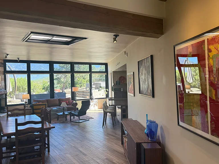 Local art, dining, living, view to back deck