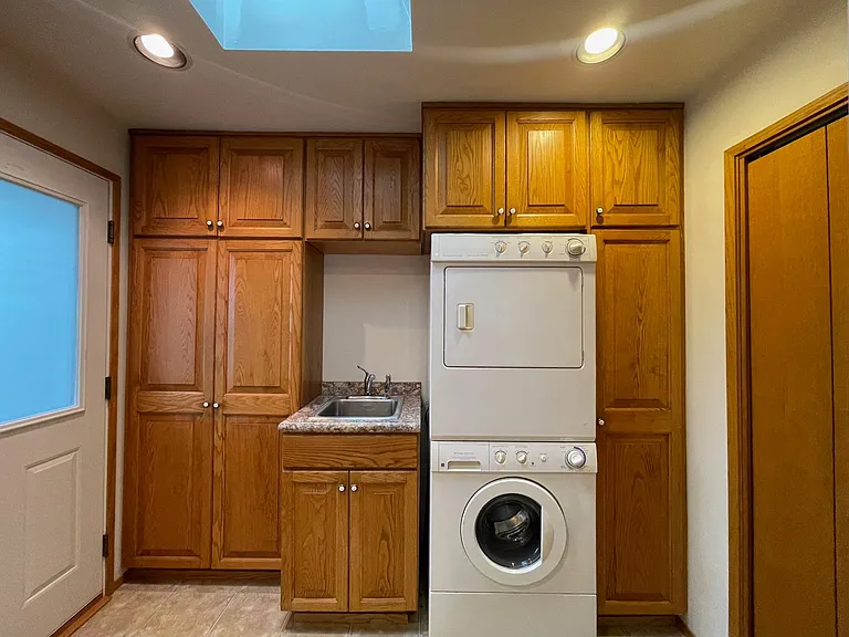 The kitchen has a washer and dryer, as well as a door to the back deck and yard.