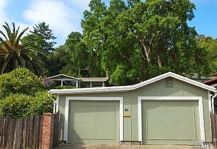view of detached 2-car garage. work bench, storage galore