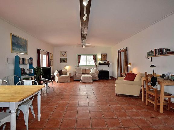 Large open concept living and dining space. French doors open to an additional backyard patio. Ceiling fans throughout. Wood fire place and heaters throughout space.