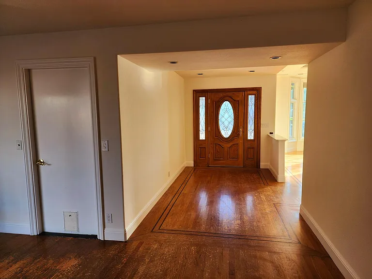 Front door foyer from inside kitchen & Family room. Small door to left is access to garage.