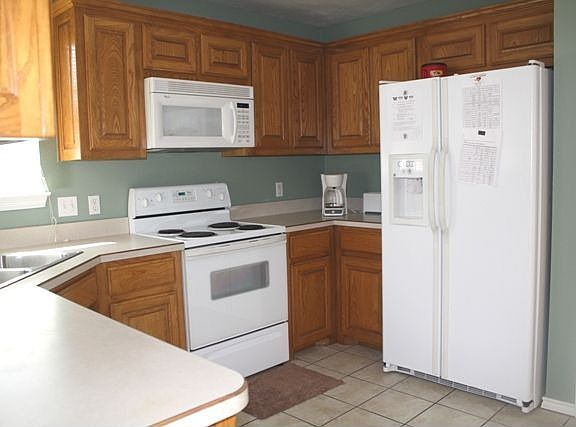 PLENTY OF WORK AND STORAGE SPACE IN KITCHEN