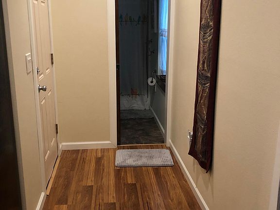 Hallway to bathroom and door to garage