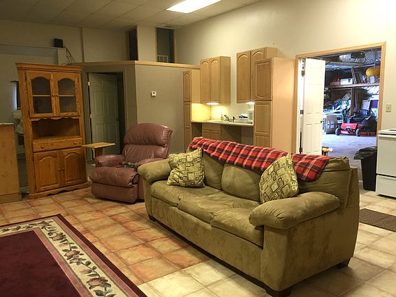 Living room area with entry to laundry in attached garage