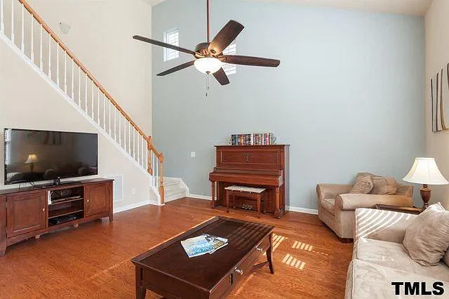 Family Room showing two-story wall with two small windows to allow light but still private