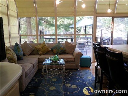 Glass atrium/hearth room with remote blinds and pendant lighting