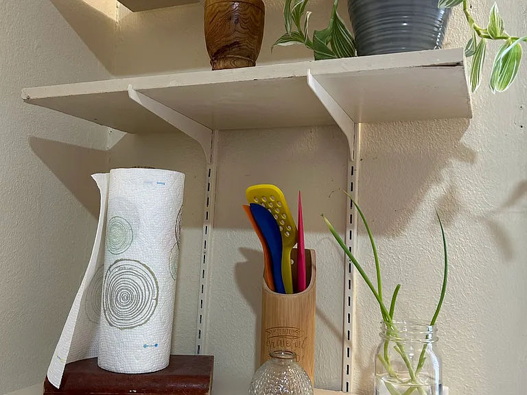 Open shelves in kitchen. Items on shelves and counter are not included.