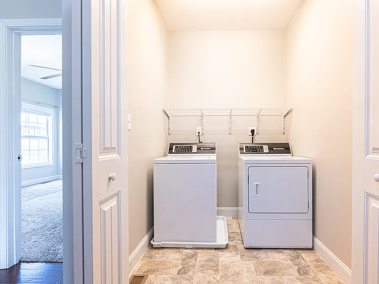 Equipped with washer and dryer and convenient shelving for storage.