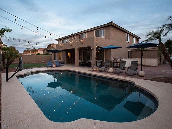 Backyard. Pool. Seating area. Basketball hoop.
