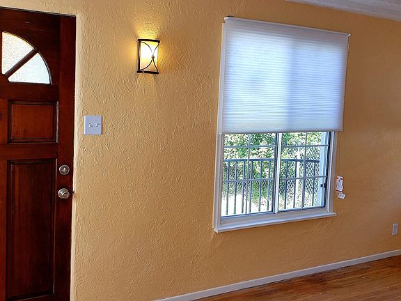 Front door and living room with 5 windows