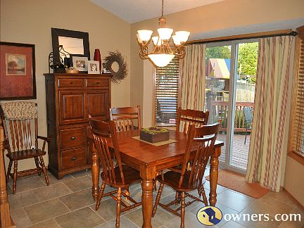 Dining area open to kitchen and with sliders to deck