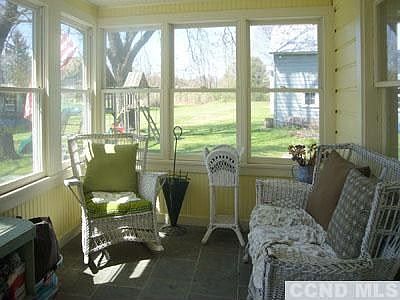 New all seasons enclosed porch/mudroom with radiant heat slate floors & new windows.