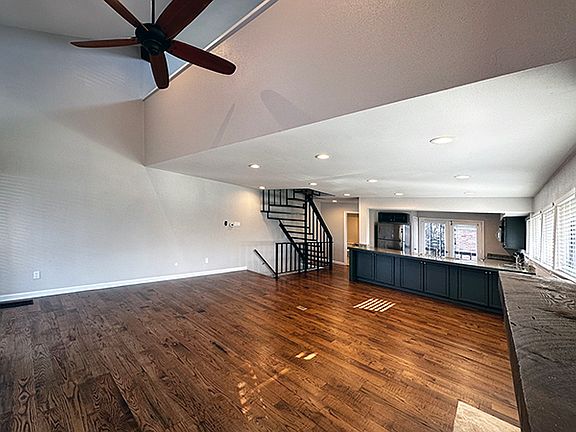 2 Story ceiling showcases this beautiful fan and looks towards the loft space