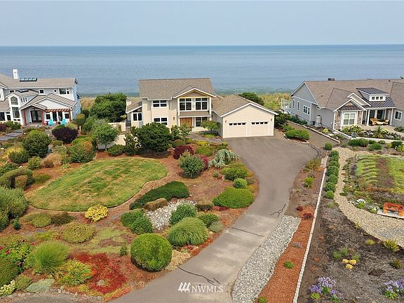 Gorgeous mature landscaping lines your private driveway