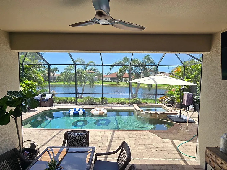 Covered outside dining with pull down shade and TV