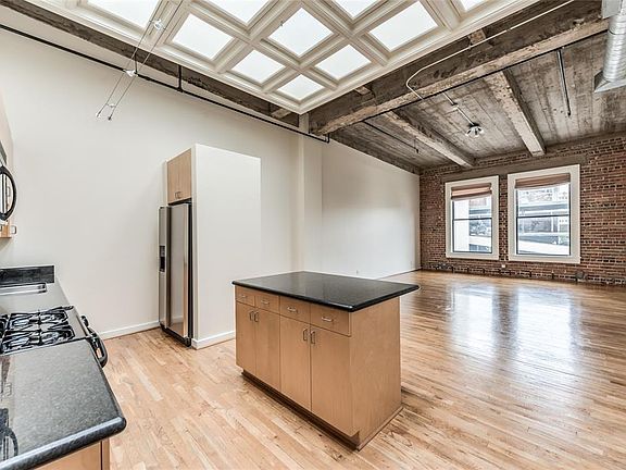 Original brick walls uncovered when building was purchased from the Southern Pacific Railroad in 1998. Open concept living areas are perfect for entertaining.