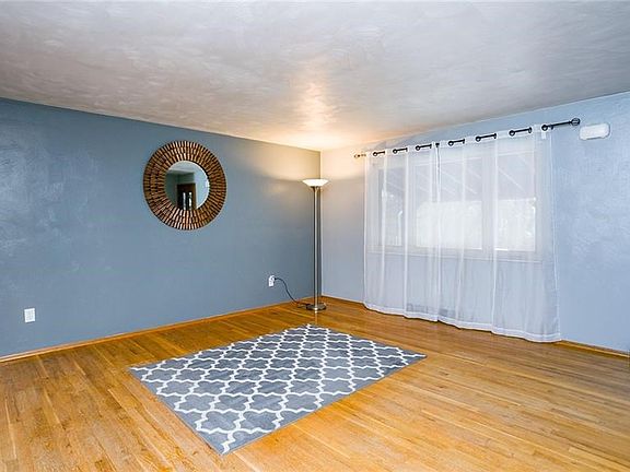 Large living room with gorgeous window.