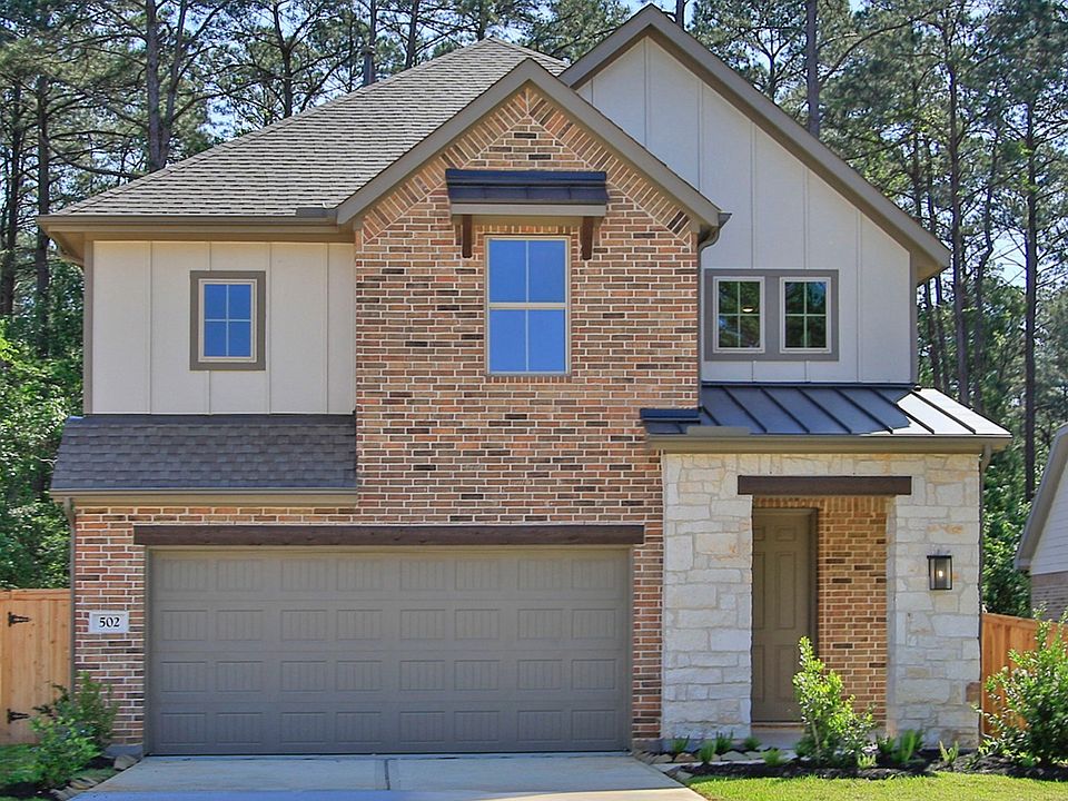 Luxurious brick facade with elegant gabled roof, nestled in The Woodlands Hills serene setting.