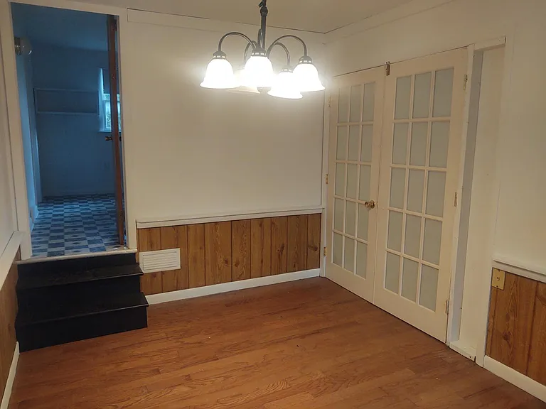 Beautiful formal dining room with french doors leading to kitchen.