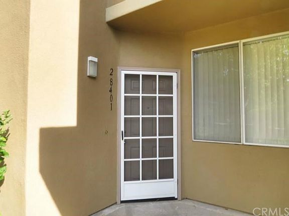 Front door with screen and covered porch.