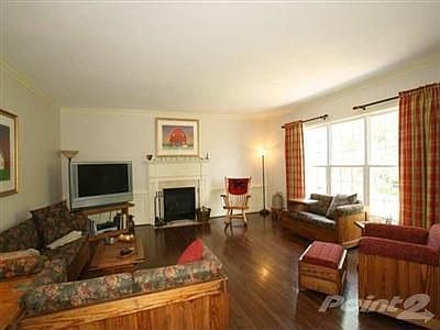 Large family room with wood floors, gas fireplace w/ remote, crown and dentil molding, wainscoting a