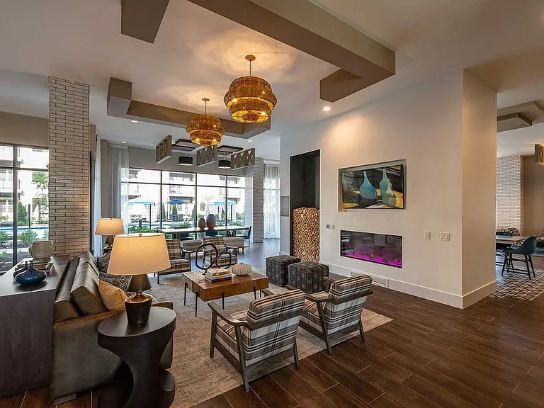 East building resident lounge with lounge seating, fireplace, and flat screen television