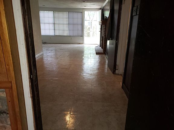 Den going out of back door into backyard.