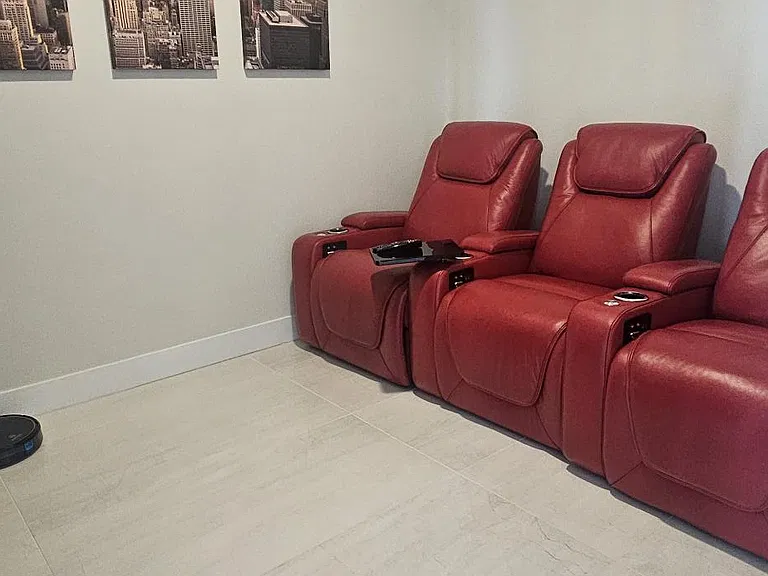den with stadium theater seating and large screen TV