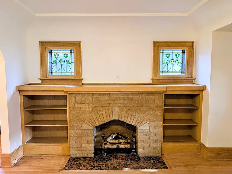 [LOWER UNIT]: newly refinished hardwood floors, build-in solid wood cabinetry. Non-functional fireplace has outlet for electric plug in faux-fire