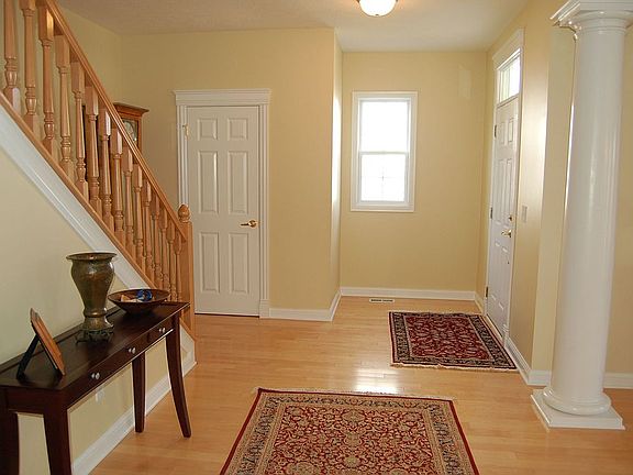 Large Foyer with decorative columns leading to living room.  