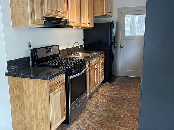 Looking into Kitchen from dining area. Door into laundry room.