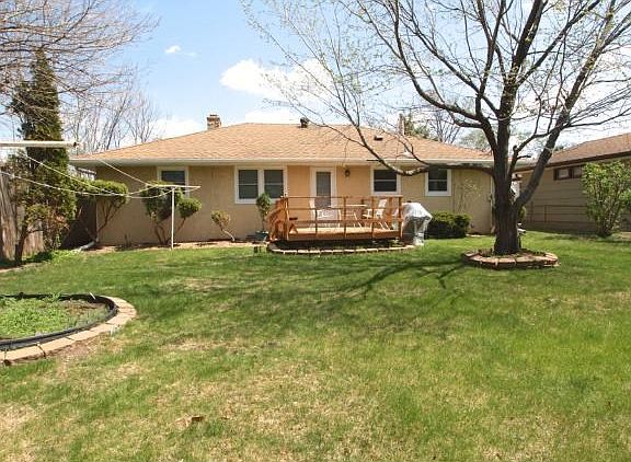 Level, easy to care for yard with deck.