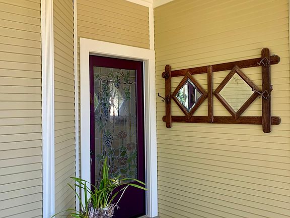 Front porch with stained glass front door.