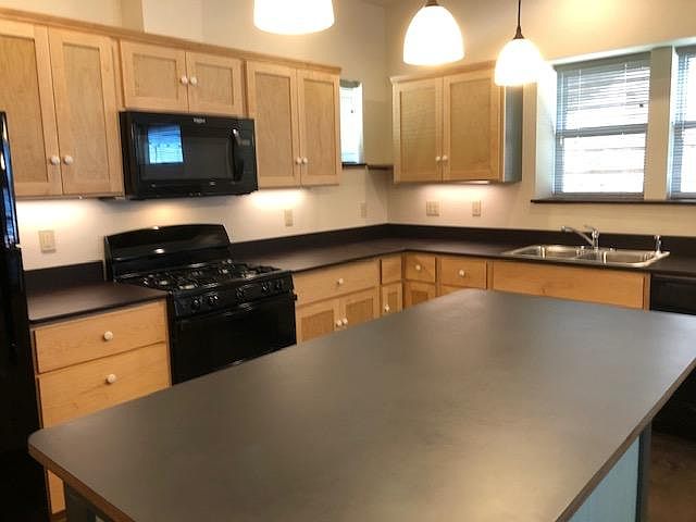Kitchen Island, PaperStone counter top. Dimmer controlled pendants illuminate island.
