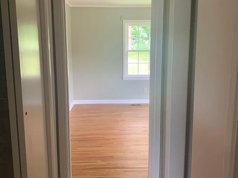 Hallway going into largest of 3 bedrooms on this end of house. Two double closets.