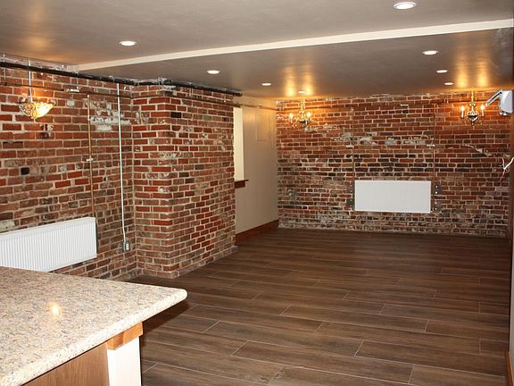 Edge of kitchen countertop looking into dining/living room. White boxes are radiators for heat.